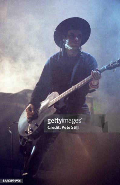 Bass player Simon Gallup of English rock band The Cure performs on stage at Wembley Arena on July 23rd 1989 in London, United Kingdom.