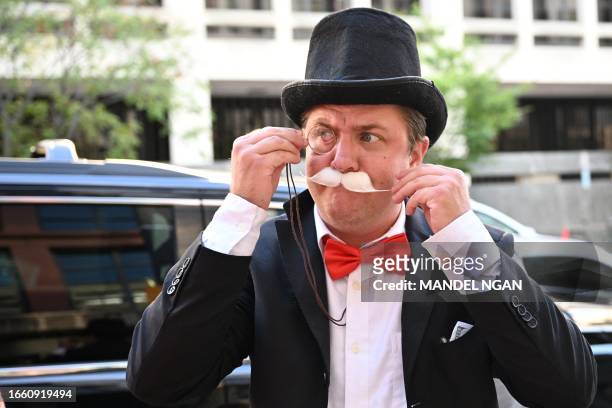 Man dressed as Monopoly board game character "Milburn Pennybags" is seen outside the E. Barrett Prettyman Courthouse in Washington, DC, on September...