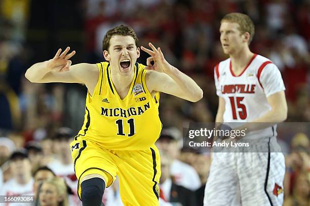 Nik Stauskas of the Michigan Wolverines reacts in the first half against Tim Henderson of the Louisville Cardinals during the 2013 NCAA Men's Final...