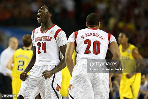 Montrezl Harrell and Wayne Blackshear of the Louisville Cardinals react after Harrell dunked the ball in the first half against the Michigan...