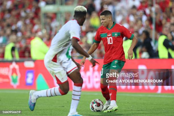 Morrocco's midfielder Amine Harit runs with the ball during the international friendly football match between Morocco and Burkina Faso at the Stade...