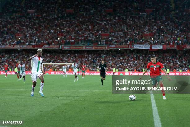 Morrocco's midfielder Amine Harit runs with the ball during the international friendly football match between Morocco and Burkina Faso at the Stade...
