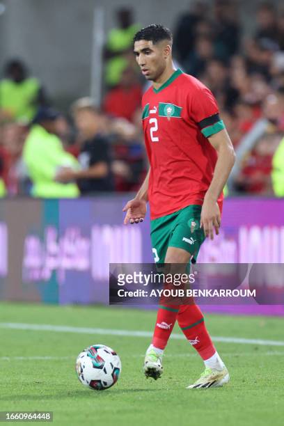 Morocco's defender Achraf Hakimi dribbles the ball during the international friendly football match between Morocco and Burkina Faso at the Stade...