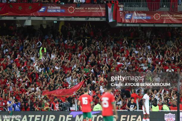 Fans cheer during the international friendly football match between Morocco and Burkina Faso at the Stade Bollaert-Delelis in Lens, northern France,...