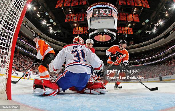 Tye McGinn and Ruslan Fedotenko of the Philadelphia Flyers skate in for a scoring attempt on goaltender Carey Price and Davis Drewiske of the...