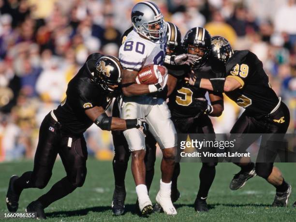Darnell McDonald, Wide Receiver for the Kansas State Wildcats is tackled by the University of Missouri Tigers defense during the NCAA Big 12...