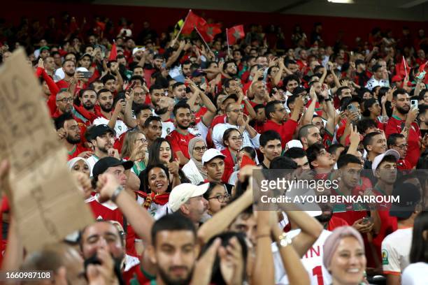 Fans cheer during the international friendly football match between Morocco and Burkina Faso at the Stade Bollaert-Delelis in Lens, northern France,...