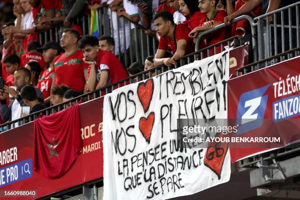 Fans display a sign during the international friendly football match between Morocco and Burkina Faso at the Stade Bollaert-Delelis in Lens, northern...