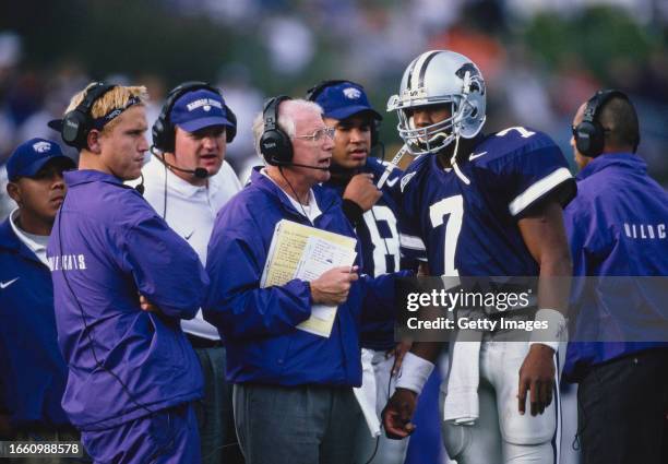 Bill Snyder, Head Coach for the Kansas State Wildcats gives play instructions to Quarterback Michael Bishop during the NCAA Big-12 Conference college...