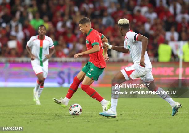 Morocco's midfielder Amine Harit prepares to pass the ball during the international friendly football match between Morocco and Burkina Faso at the...