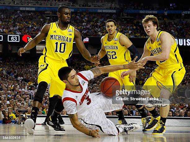 Peyton Siva of the Louisville Cardinals attempts to control the ball in the second half as he falls down against Tim Hardaway Jr. #10, Jordan Morgan...
