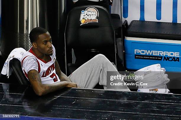 Injured guard Kevin Ware of the Louisville Cardinals watches his teammates playa against the Michigan Wolverines during the 2013 NCAA Men's Final...