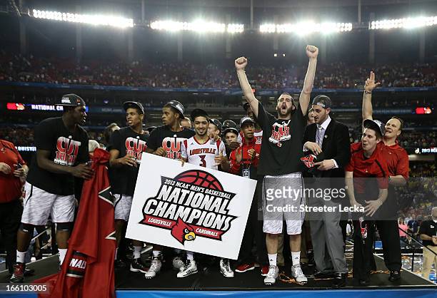 Peyton Siva and Luke Hancock of the Louisville Cardinals celebrate with their teammates after they won 82-76 against the Michigan Wolverines during...
