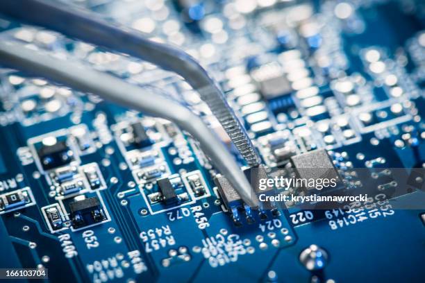 assembling a circuit board. - microchip production line stock pictures, royalty-free photos & images