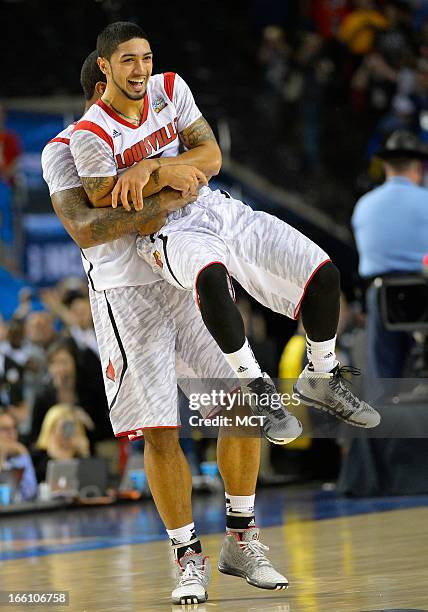 Peyton Siva of the Louisville Cardinals, front, celebrates with teammate Chane Behanan after, Louisville defeate Michigan 82-76 in the NCAA Men's...