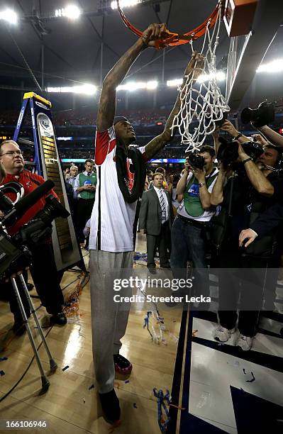 Injured guard Kevin Ware of the Louisville Cardinals celebrates as he cuts down the net after Louisville won 82-76 against the Michigan Wolverines...