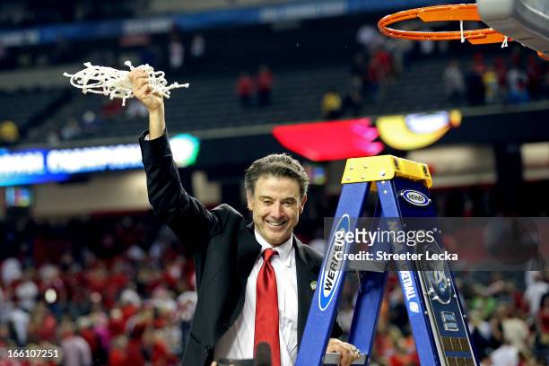 Head coach Rick Pitino of the Louisville Cardinals celebrates with the net after they won 82-76 against the Michigan Wolverines during the 2013 NCAA...
