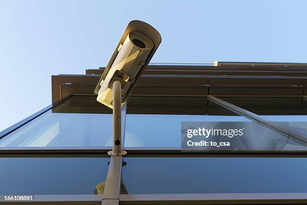 security camera on the glass building - guarding building stock pictures, royalty-free photos & images