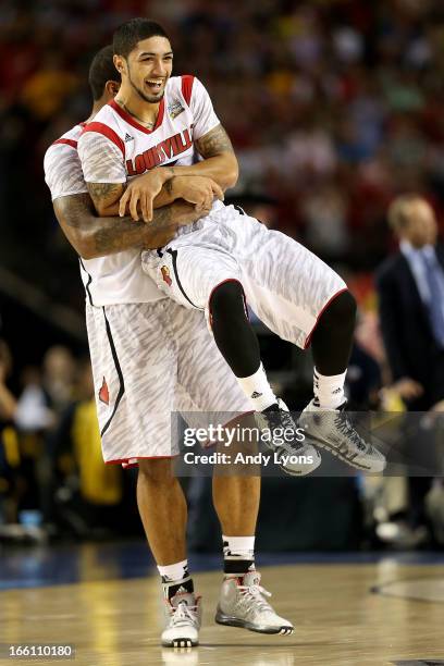 Chane Behanan and Peyton Siva of the Louisville Cardinals celebrate their 82-76 win against the Michigan Wolverines during the 2013 NCAA Men's Final...