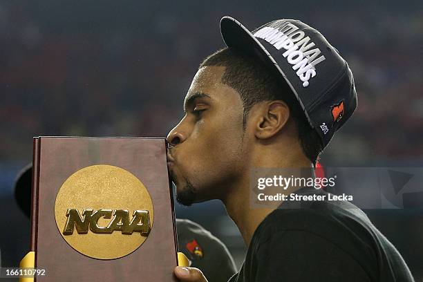 Chane Behanan of the Louisville Cardinals kisses the National CHampionship trophy after they won 82-76 against the Michigan Wolverines during the...