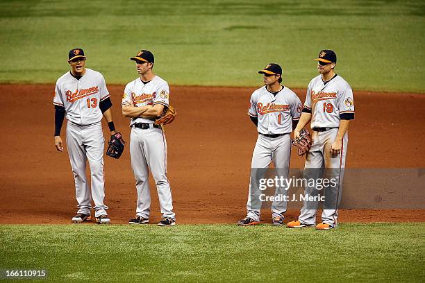 Infielders Manny Machado , J.J. Hardy, Brian Roberts and Chris Davis of the Baltimore Orioles await a pitching change against the Tampa Bay Rays...