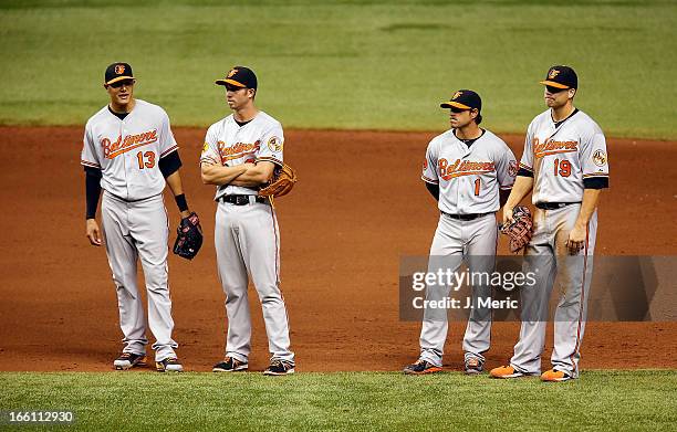 Infielders Manny Machado , J.J. Hardy, Brian Roberts and Chris Davis of the Baltimore Orioles await a pitching change against the Tampa Bay Rays...