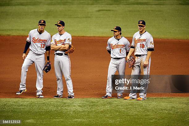 Infielders Manny Machado , J.J. Hardy, Brian Roberts and Chris Davis of the Baltimore Orioles await a pitching change against the Tampa Bay Rays...