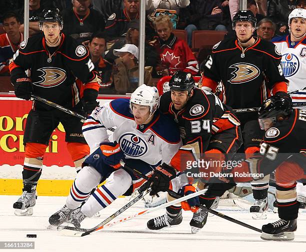 Taylor Hall of the Edmonton Oilers battles for the puck against Daniel Winnik of the Anaheim Ducks on April 8, 2013 at Honda Center in Anaheim,...