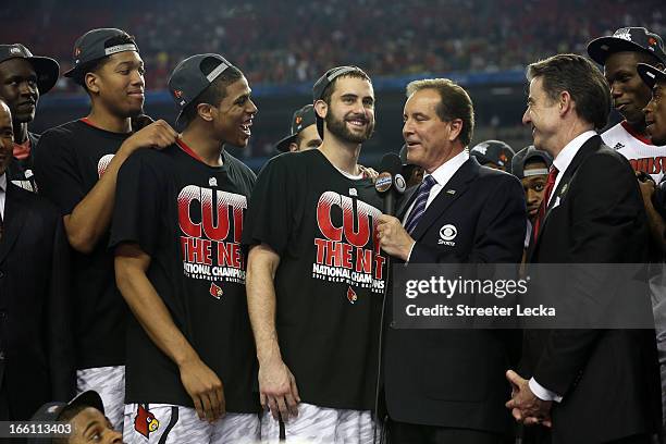 Luke Hancock of the Louisville Cardinals is interviewed by CBS announcer Jim Nantz as he celebrates with teammates after they won 82-76 against the...