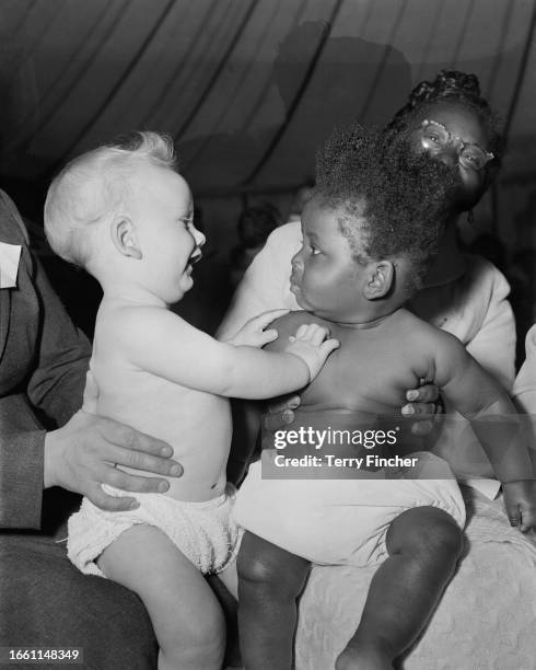 Two infants competing in a Bank Holiday Monday Baby Show at Roundwood Park in Willesden, London, August 6th 1956. Stephen Moss , aged 7 months and...