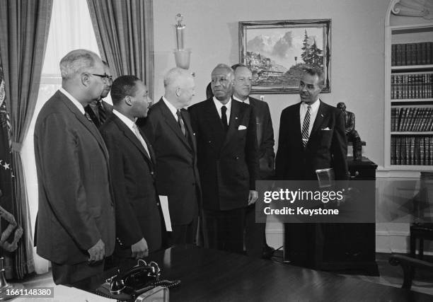 President Dwight D Eisenhower pictured in his office at the White House with four civil rights leaders following a meeting in Washington DC, June...