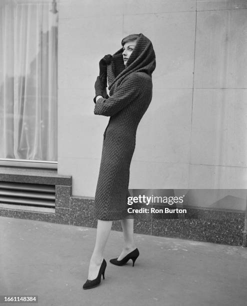 Model wearing a cowl-hooded jersey dress from the Matita autumn collection in London, September 6th 1957.