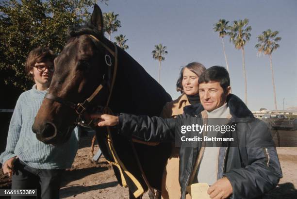Racehorse 'Seattle Slew' pictured with stable hand Donald Carrol, owner Karen Taylor and jockey Jean Cruguet at Hialeah, Florida, March 24th 1977....