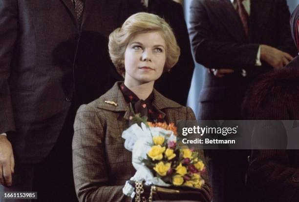 Princess Marie-Astrid of Luxembourg holding a small bouquet of flowers, circa 1977.