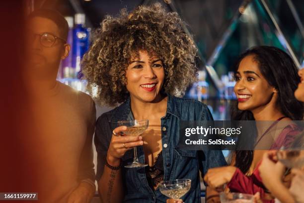 friends in the spotlight - nightlife bar stock pictures, royalty-free photos & images
