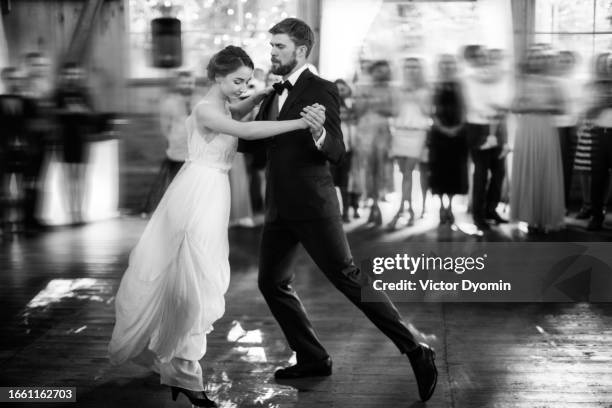 dancing newlyweds on the crowded dance floor - waltzing stock pictures, royalty-free photos & images