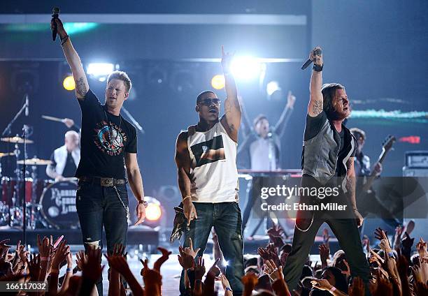 Recording artists Brian Kelley and Tyler Hubbard of Florida Georgia Line perform with rapper Nelly onstage during Tim McGraw's Superstar Summer Night...