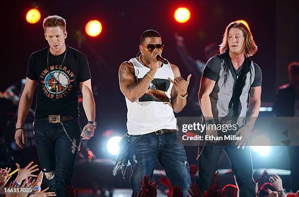 Recording artists Brian Kelley and Tyler Hubbard of Florida Georgia Line perform with rapper Nelly onstage during Tim McGraw's Superstar Summer Night...