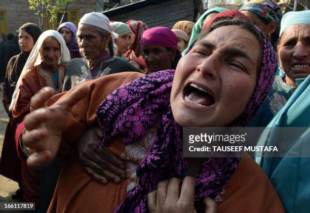 Kashmiri villagers mourn during the funeral of ruling National Conference sarpanch, Ghulam Mohammed Lone in Kulpora village of south Kashmir's...
