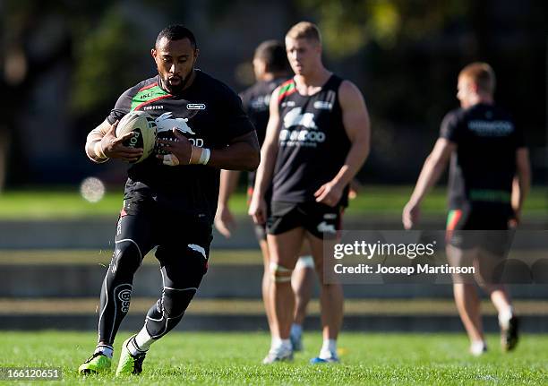 Roy Asotasi runs with the ball during a South Sydney Rabbitohs NRL training session at Redfern Oval on April 9, 2013 in Sydney, Australia.