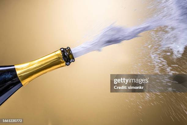 close-up of champagne exploding - champagne stock pictures, royalty-free photos & images