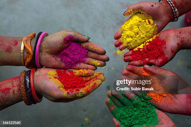 hand with colours at holi festival,india. - holi hands stock pictures, royalty-free photos & images