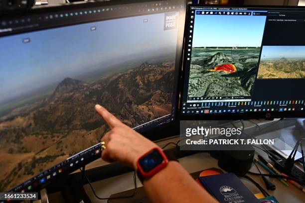 Cal Fire intelligence specialist Suzann Leininger shows fire modelling software viewed alongside a camera feed from the ALERTCalifornia wildfire...