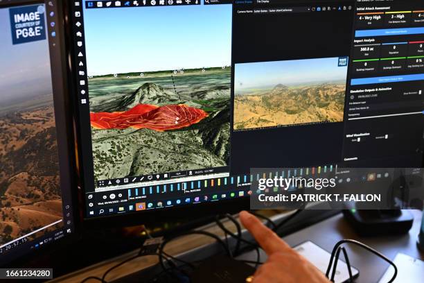 Cal Fire intelligence specialist Suzann Leininger shows fire modelling software viewed alongside a camera feed from the ALERTCalifornia wildfire...