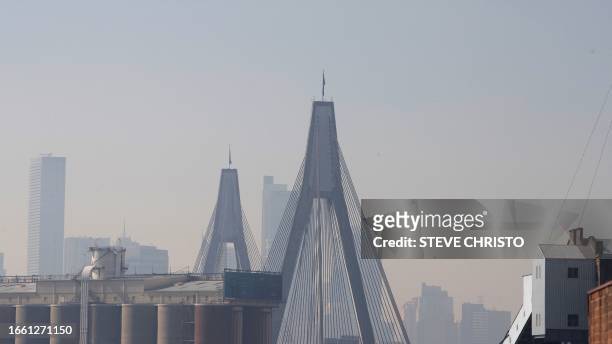 The Anzac Bridge and skyline are seen shrouded by smoke in Sydney on September 13 as a smoky haze blankets Australia's scenic Sydney Harbour, after a...