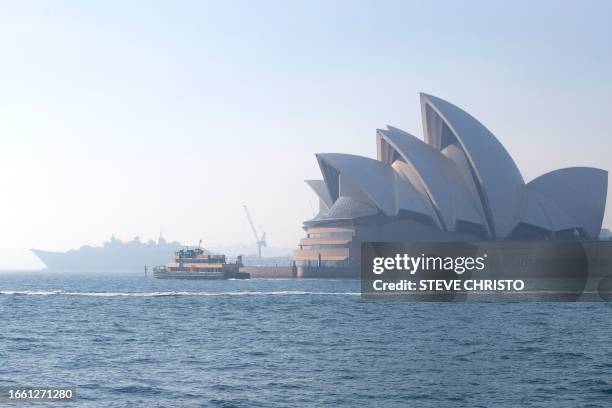 The Sydney Opera House is seen shrouded by smoke on September 13 as a smoky haze blankets Australia's scenic Sydney Harbour, after a ring of...