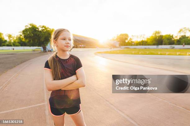 portrait of a young girl athlete on the stadium background at sunset - young athletes stock pictures, royalty-free photos & images