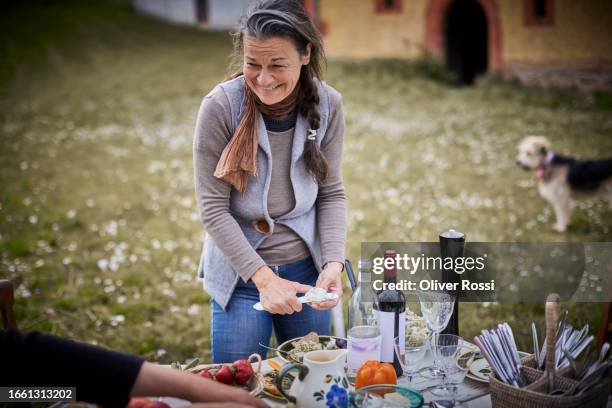 happy mature woman at table in garden - bell pepper field stock pictures, royalty-free photos & images