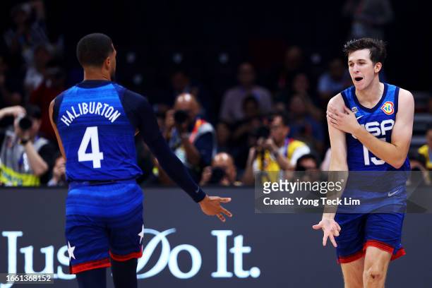 Austin Reaves of the United States celebrates with Tyrese Haliburton after scoring a three-pointer in the third quarter during the FIBA Basketball...