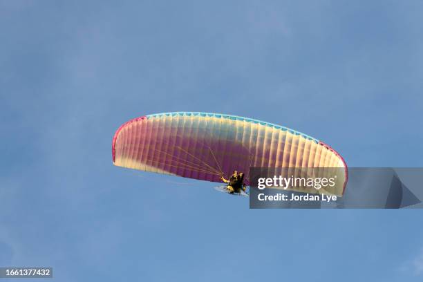 powered paragliding during sunrise - motor paraglider stock pictures, royalty-free photos & images